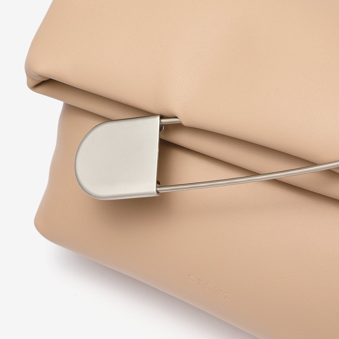 Safety pin embellished flap crossbody bag