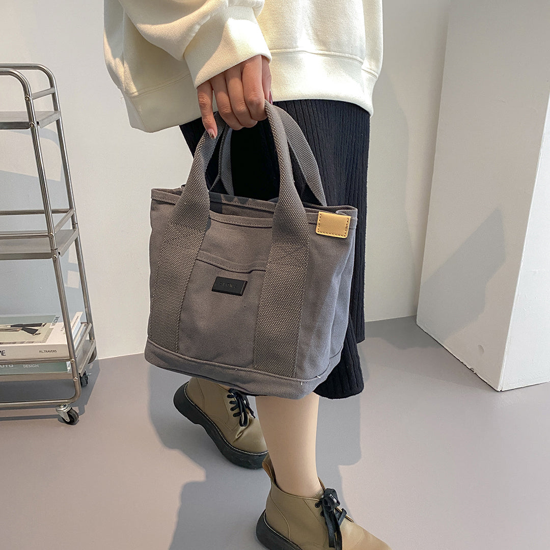Structural interior multiple compartment canvas handbag