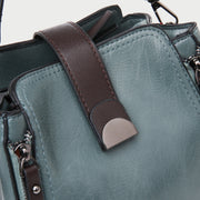 Half moon metal embellished strap zip side PU leather bucket bag