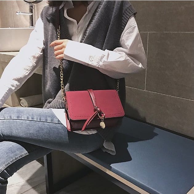 Knotted strap metal disc embellished PU leather crossbody bag