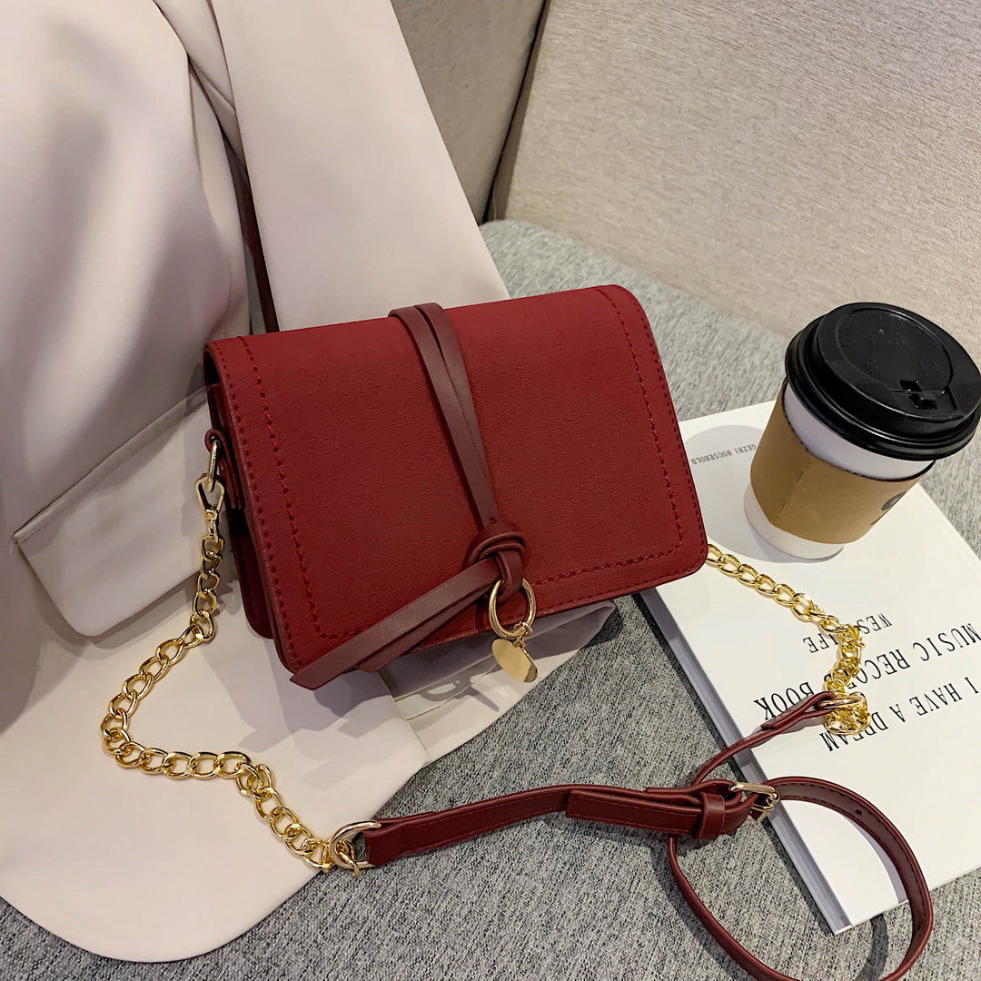 Knotted strap metal disc embellished PU leather crossbody bag