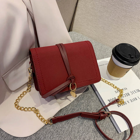 Knotted strap metal disc embellished PU leather crossbody bag