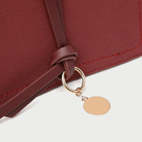 Knotted strap metal disc embellished PU leather crossbody bag
