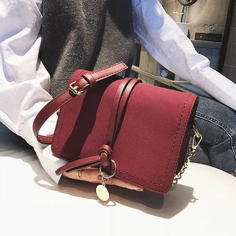Knotted strap metal disc embellished PU leather crossbody bag