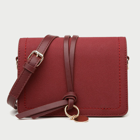 Knotted strap metal disc embellished PU leather crossbody bag