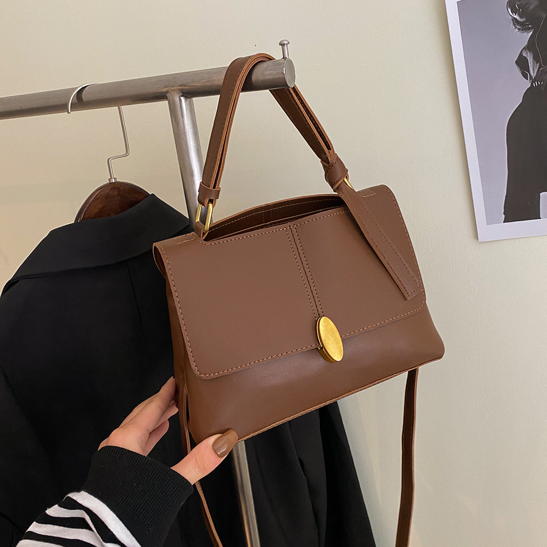Oval metal clasp open-top flap PU leather crossbody bag