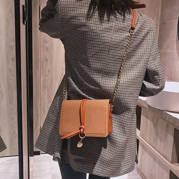 Knotted strap metal disc embellished PU leather crossbody bag