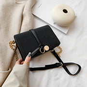 Knotted strap metal disc embellished PU leather crossbody bag