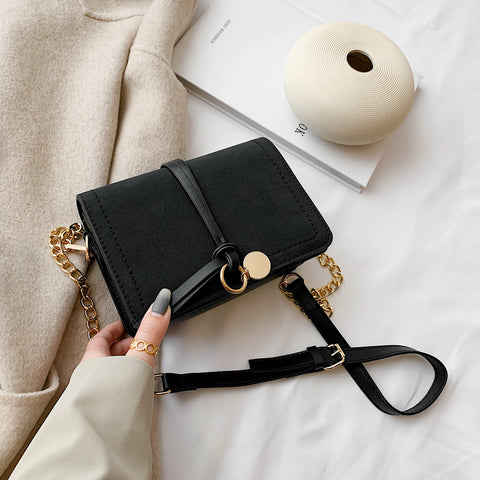Knotted strap metal disc embellished PU leather crossbody bag
