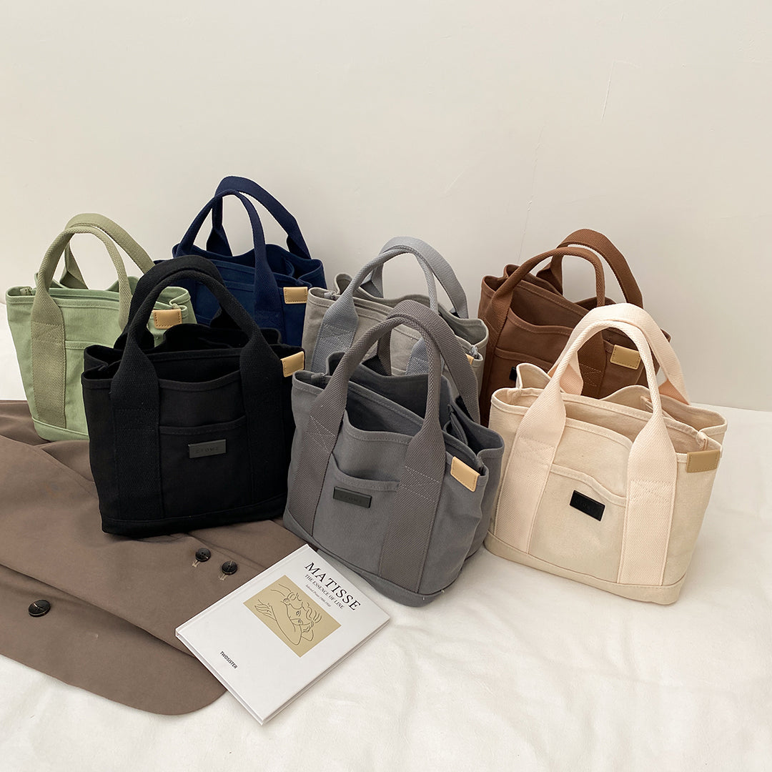 Structural interior multiple compartment canvas handbag