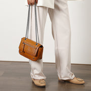 Zipped front flap studded PU leather crossbody bag