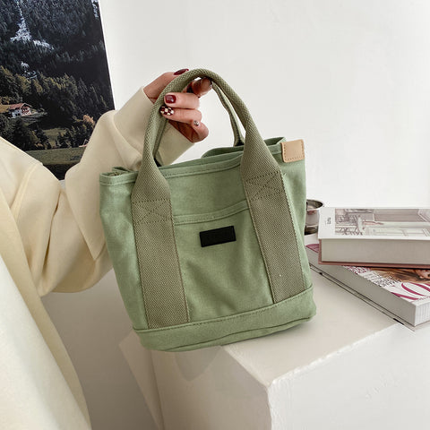 Structural interior multiple compartment canvas handbag