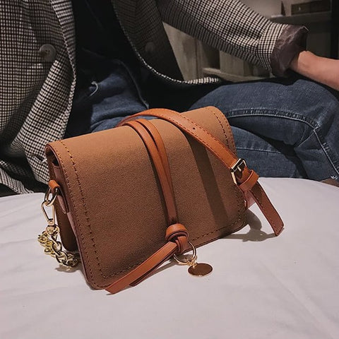 Knotted strap metal disc embellished PU leather crossbody bag