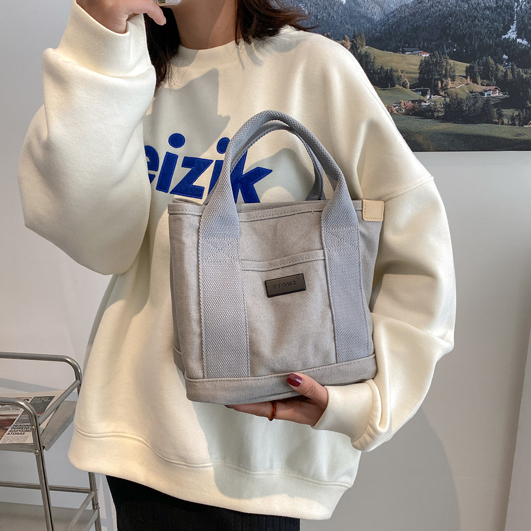 Structural interior multiple compartment canvas handbag