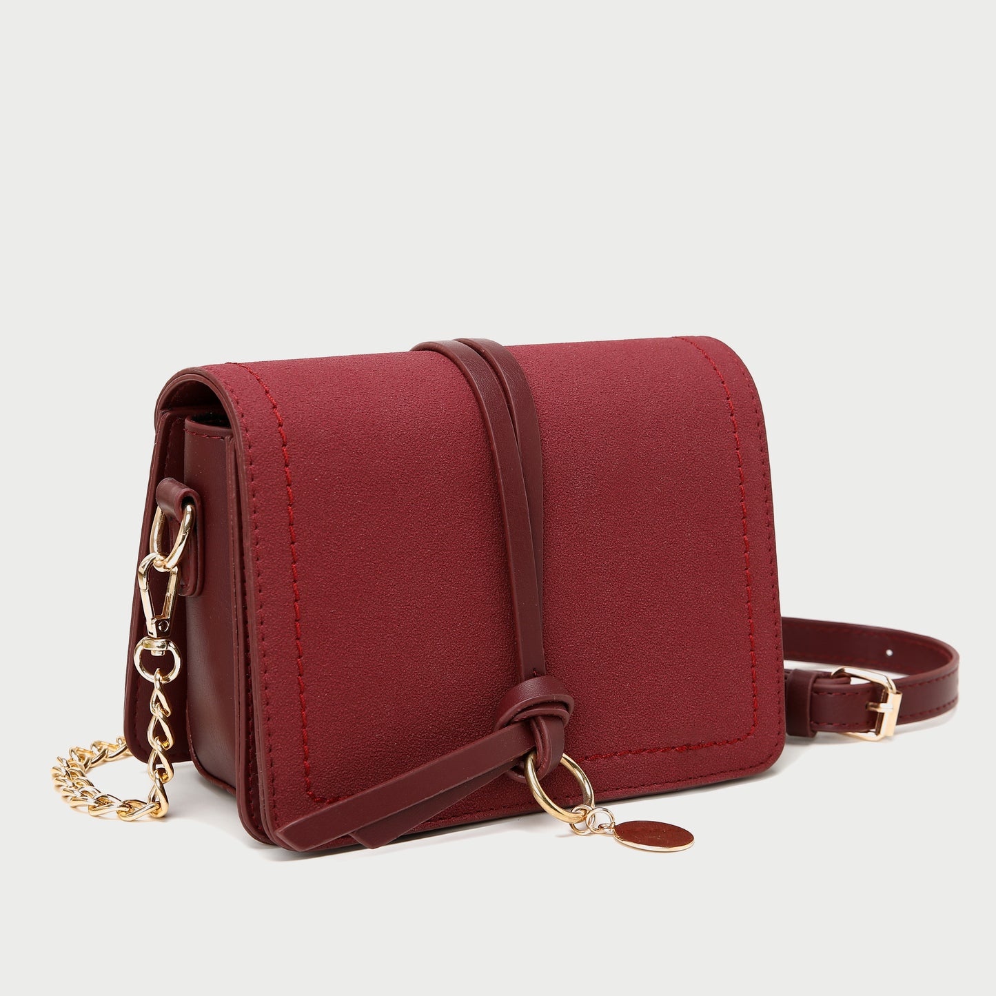Knotted strap metal disc embellished PU leather crossbody bag